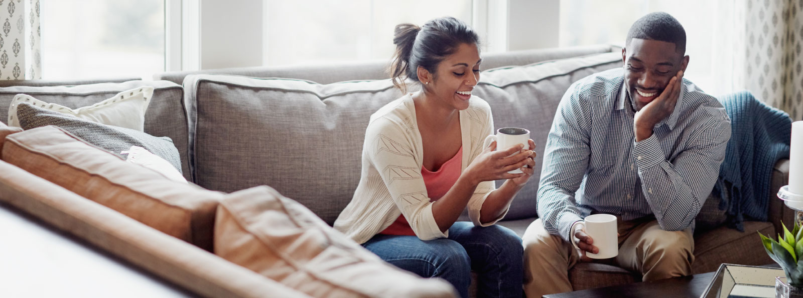 Young couple having coffee at home